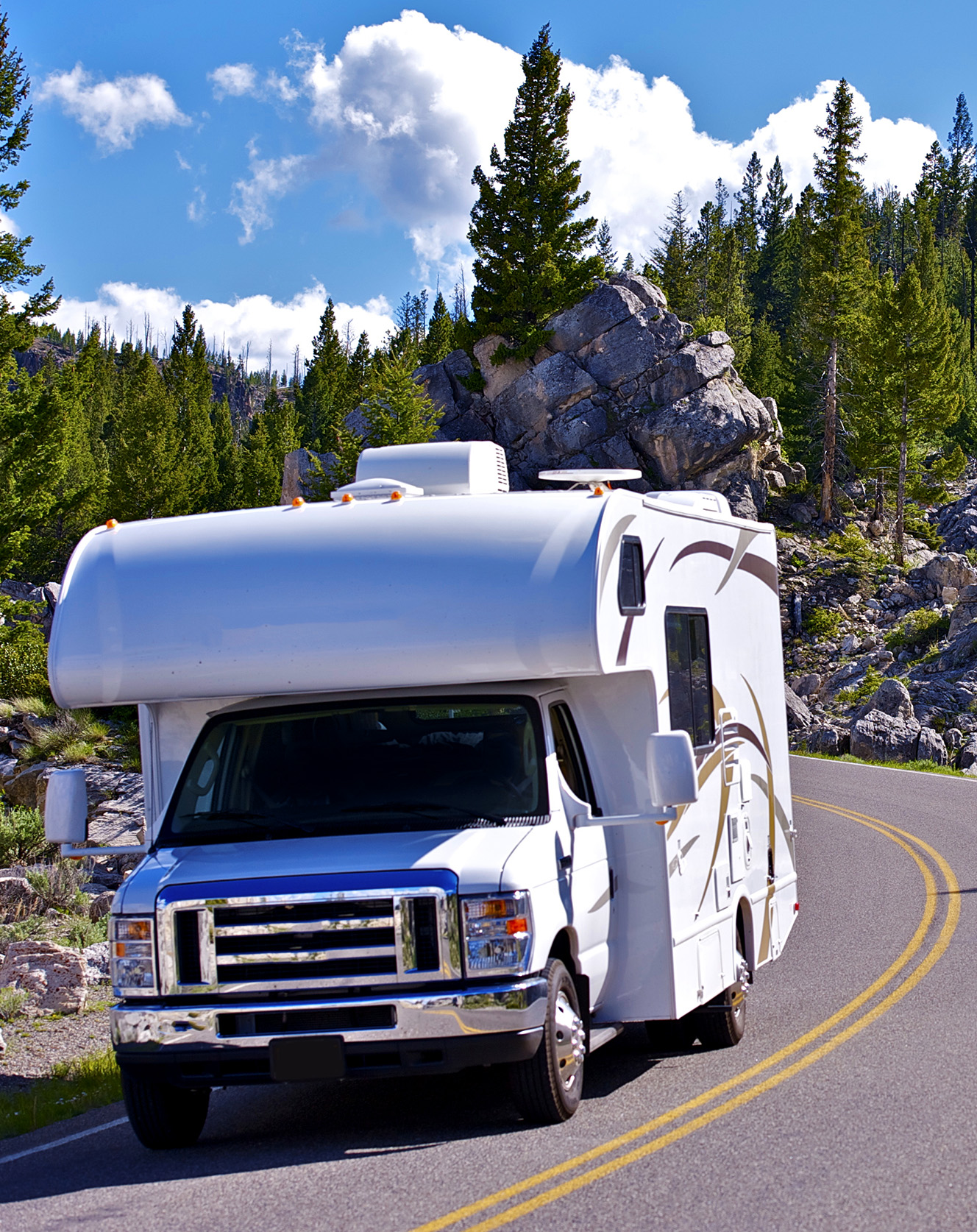 Motorhome driving on a Rocky Mountain road after an RV inspection