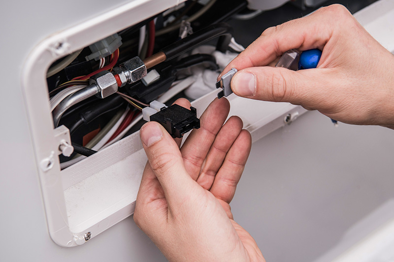 Checking the wiring of a motorhome while preforming rv inspection services